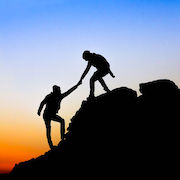 Silhouette of helping hand between two climber