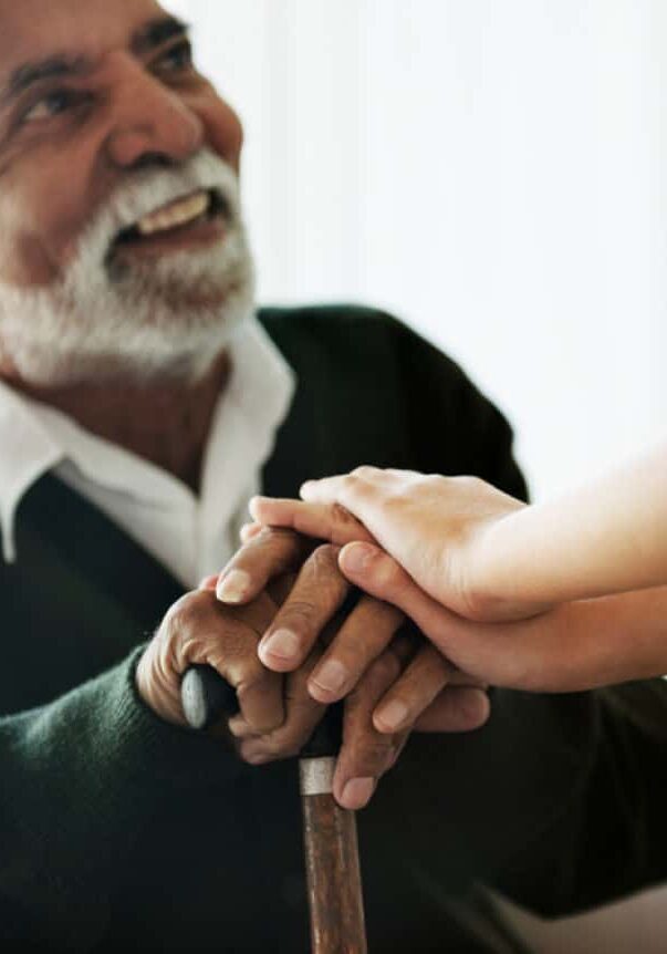 Elderly Man Being Supported