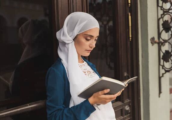 Young muslim woman reading